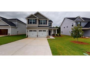 Charming two-story home with a two-car garage and well-maintained lawn, perfect for families at 150 Hanover Ct, Clayton, NC 27527