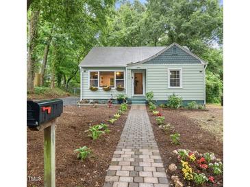 Charming home with a stone walkway, beautiful landscaping and flower boxes under the front windows at 1905 Bivins St, Durham, NC 27707