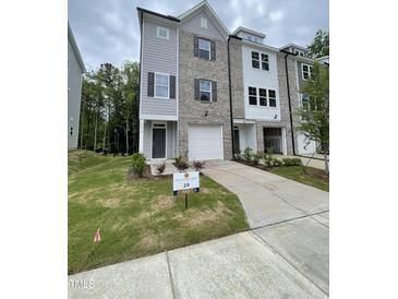 Charming new construction townhome with gray brick and siding and a one car garage at 1912 Fishamble St # 20, Fuquay Varina, NC 27526