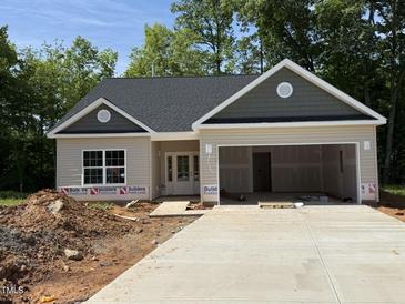 Charming, newly-constructed one story home featuring a two-car garage and neutral toned siding at 1995 Meadowview Dr, Graham, NC 27253