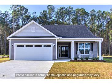 Charming single-story home featuring a two-car garage, covered entry, and well-manicured lawn at 1998 Meadowview Dr, Graham, NC 27253