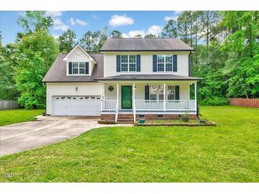 Charming two-story home with a well-manicured front yard and inviting front porch at 212 Spearhead Pl, Clayton, NC 27520