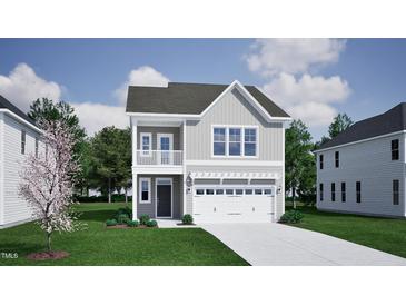 Charming two-story home with gray siding and a front-facing two car garage at 256 Meadowbark Bnd # 45, Garner, NC 27529
