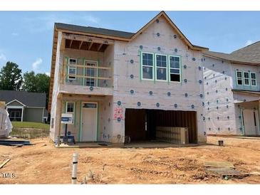 New construction of a two-story home with visible framing and large window openings at 256 Meadowbark Bnd # 45, Garner, NC 27529