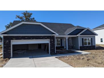 Charming single-story home with a mix of stone and vinyl siding and attached garage at 39 Braddock Ct, Garner, NC 27529