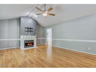 Inviting living room with hardwood floors, fireplace, and lots of natural light at 419 Jera Dr, Garner, NC 27529