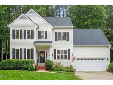 Charming two-story home with manicured lawn, black shutters, and a cozy front porch at 4329 Hawksong Pl, Cary, NC 27518