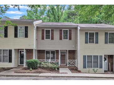 Charming townhome featuring neutral siding, brick accents, and well-maintained landscaping at 4658 Fawnbrook Cir, Raleigh, NC 27612
