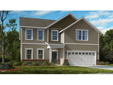 Charming two-story home with a manicured lawn and an attached two-car garage at 535 Claftin St, Sanford, NC 27330