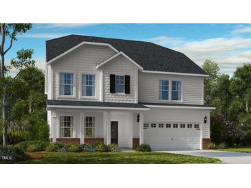 Charming two-story home featuring white siding, a two-car garage, and a welcoming front porch at 539 Claftin St, Sanford, NC 27330