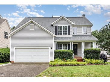 Charming two-story home featuring a well-maintained yard and attached two-car garage at 5637 Yates Garden Ln, Raleigh, NC 27606