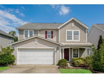 Charming two-story home with a well-maintained yard, attached garage, and craftsman-style details at 6101 Ricker Rd, Raleigh, NC 27610