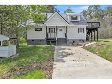 Charming two-story home featuring a gray metal roof and covered porch with black trim at 852 Fred Wilder Rd, Franklinton, NC 27525