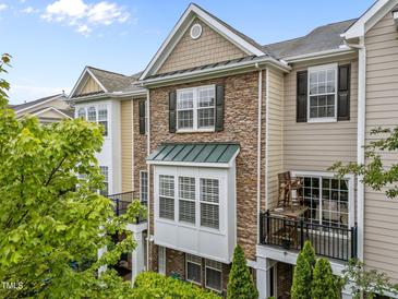 Beautiful exterior elevation with a stone facade and outdoor balcony, perfect for enjoying the neighborhood views at 9164 Wooden Rd, Raleigh, NC 27617
