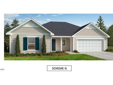 Charming one-story home with neutral siding, crisp white trim, and a two-car garage on a well manicured lawn and landscape at 145 Caspian Ct, Lillington, NC 27546