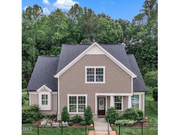 Charming home with manicured lawn, black fence, and beautiful landscaping at 151 Bridge St, Hillsborough, NC 27278