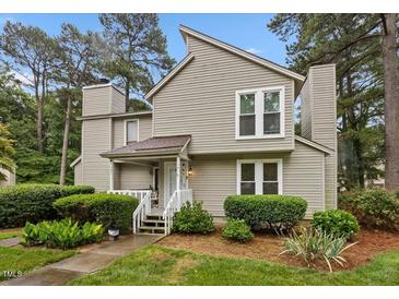 Charming two-story home with a well-manicured lawn and mature trees, and private front entrance at 151 Lake Pine Dr, Cary, NC 27511