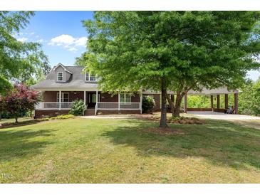 Charming brick home with inviting front porch and well-manicured lawn and a convenient covered parking area at 1852 Gwyn Rd, Burlington, NC 27217