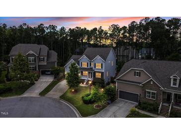 Beautiful two-story home featuring professional landscaping and a welcoming front entrance at sunset at 208 Cecelia Ct, Cary, NC 27519