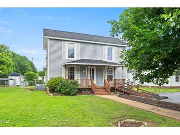 Charming two-story home with a covered front porch and handicap access ramp at 2527 Ossipee Front St, Elon, NC 27244