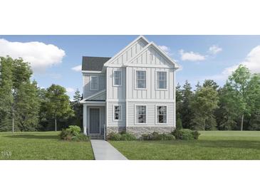 Charming two-story home with white siding, stone accents, and a well-manicured front lawn, ideal for a growing Gathering at 2924 Ocean Sunrise Dr, Wake Forest, NC 27587