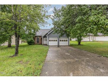 Charming two-story home with a two-car garage, and a landscaped front yard at 3306 Woodland Park Rd, Durham, NC 27703