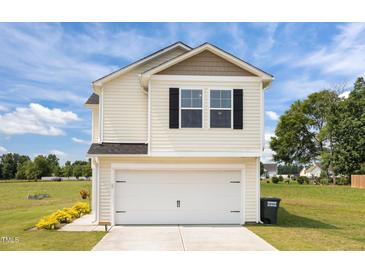 Charming two-story home with a two-car garage and well-maintained lawn and landscaping at 4097 Cordiality Church Rd, Nashville, NC 27856