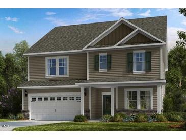 Charming two-story home with a two car garage, neutral siding, and inviting curb appeal at 519 Claftin St, Sanford, NC 27330