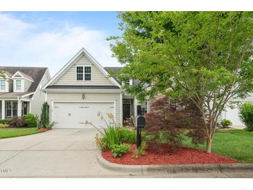 Charming home featuring a well-maintained front yard and a two-car garage at 5233 Greymoss Ln, Apex, NC 27539