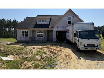 Charming two-story new home with classic architectural details awaiting finishing touches at 82 Laramie Ln, Selma, NC 27576