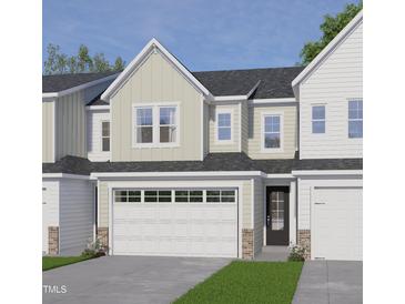 Charming townhome featuring a two-car garage, neutral siding and a welcoming entrance at 8935 Kennebec Crossing Dr # 57, Angier, NC 27501