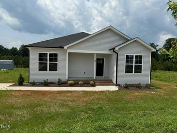 Charming single-story home with light siding, a black door, and a well-manicured lawn at 90 Brookhaven Dr, Spring Hope, NC 27882