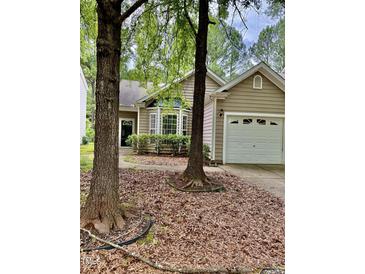 Charming home featuring a bay window and an attached one-car garage with trees at 1017 Red Hat Ln, Durham, NC 27713