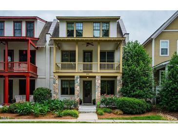 Charming two-story home with a covered front porch and stone accents and mature landscaping at 253 Tobacco Farm Way, Chapel Hill, NC 27516