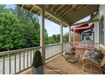 Inviting covered porch with comfortable seating, area rug and views of the neighborhood at 253 Tobacco Farm Way, Chapel Hill, NC 27516