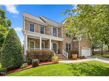 Beautiful brick home with manicured lawn and covered front porch with white columns at 4 Pickard Pl, Durham, NC 27703