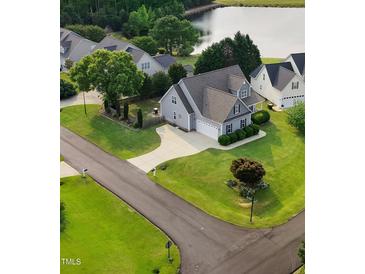 Stunning gray home with a well-manicured lawn in a lakeside community at 479 Manchester Trail, Clayton, NC 27527