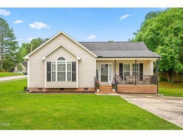 Charming single-story home with a welcoming front porch, green lawn, and classic siding at 601 Southampton Dr, Knightdale, NC 27545