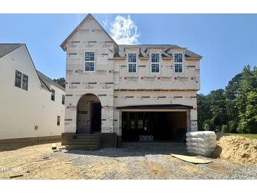 Exterior view of home under construction with visible windows, garage, and building materials at 6505 Burnette Flower Way, Raleigh, NC 27612