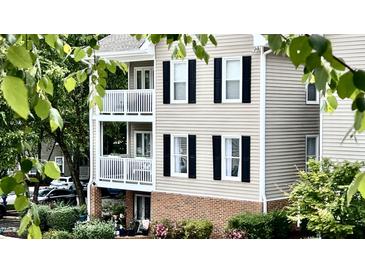 Exterior of the home with balconies, black shutters, and landscaped gardens at 923 Springfork Dr, Cary, NC 27513