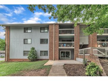 Brick apartment building featuring upper level balconies and grey siding at 1008 Sandlin Pl # J, Raleigh, NC 27606
