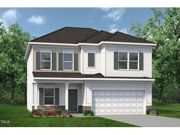 Charming two-story home with a two-car garage, stone accents, and a beautifully landscaped yard at 115 Mildred Place, Broadway, NC 27505