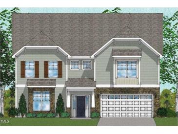 Charming two-story home with stone accents, attached garage, and well-manicured lawn and professional landscaping at 221 N Maple Walk Walk # 221, Garner, NC 27529