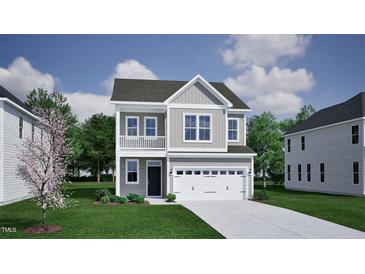 Charming two-story home featuring gray siding, white trim, a balcony, and an attached two-car garage at 263 Meadowbark Bnd # 33, Garner, NC 27529