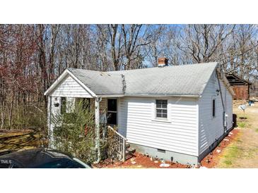 Charming single-story home with white siding, a grey roof, and cozy porch at 2778 Morton-Pulliam Rd, Roxboro, NC 27574