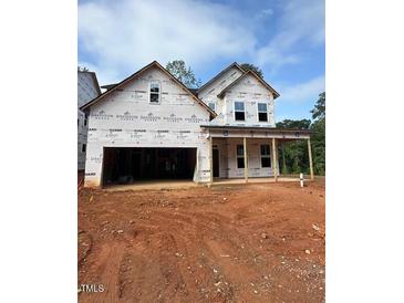 A partially built two-story home displays a covered porch, visible framing, and an attached two-car garage at 432 Golden Dragonfly St, Wake Forest, NC 27587