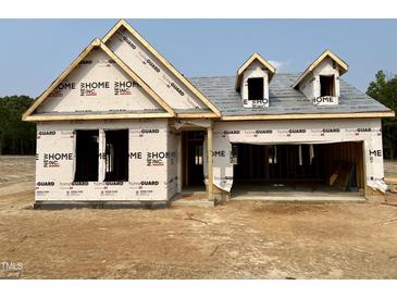 Exterior view of a home under construction with a two-car garage and covered entrance at 455 Beacon Hill Rd # 28, Lillington, NC 27546