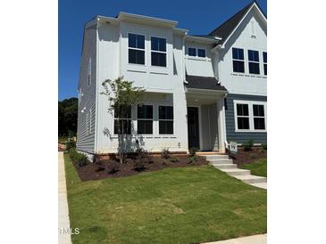 Attractive two-story home with modern design, complemented by a well-manicured lawn and landscaping at 611 Callan View Ave, Wake Forest, NC 27587