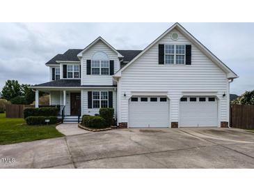 Charming two-story home with a two-car garage and well-maintained landscaping at 1100 Open Field Dr, Garner, NC 27529
