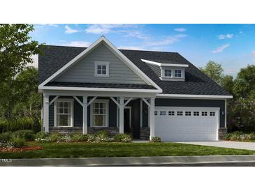 Charming craftsman-style home featuring a well-manicured lawn and an attached two-car garage at 1124 Sun Springs Rd, Wake Forest, NC 27587
